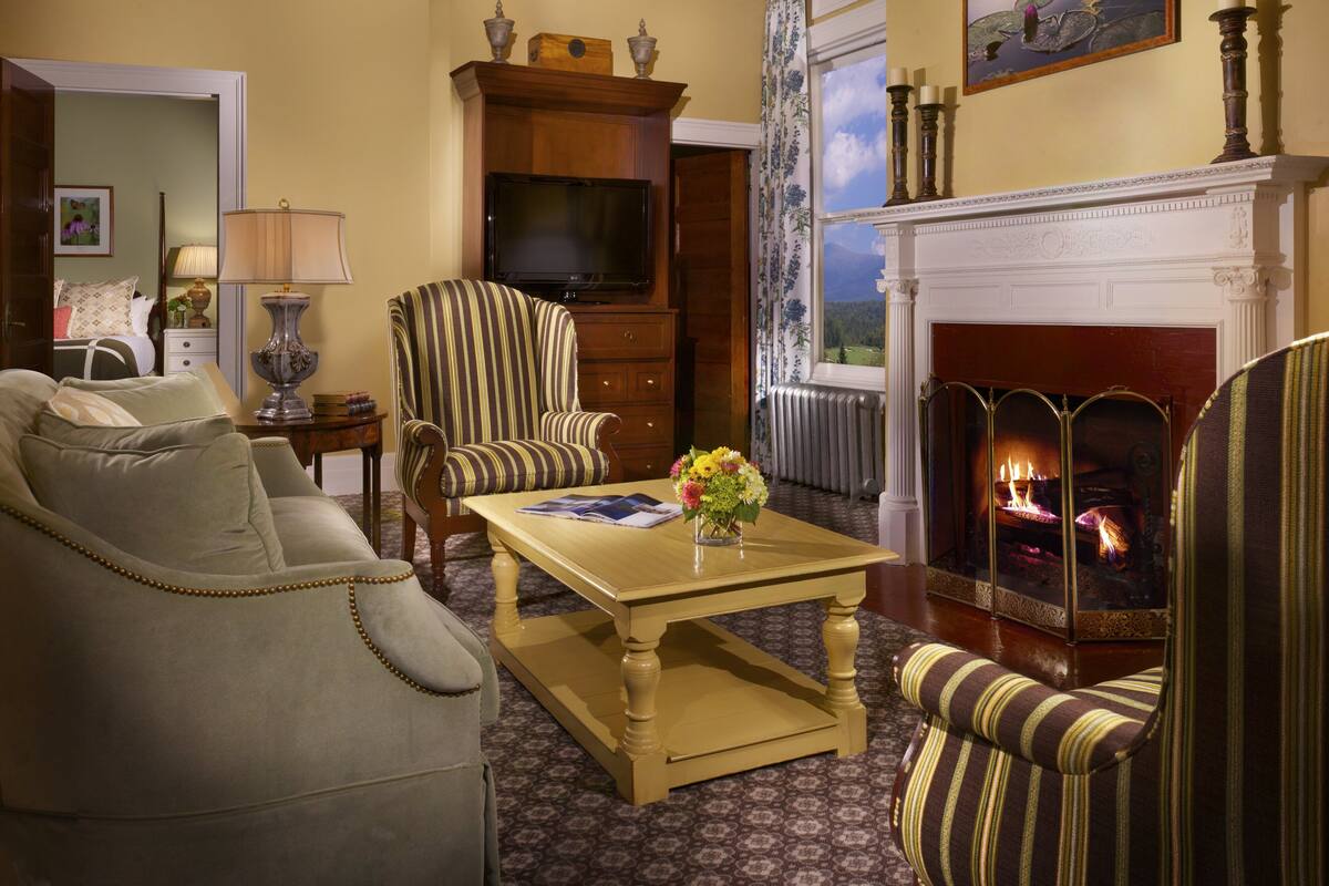 A living room with a fireplace, a television, and a sofa.