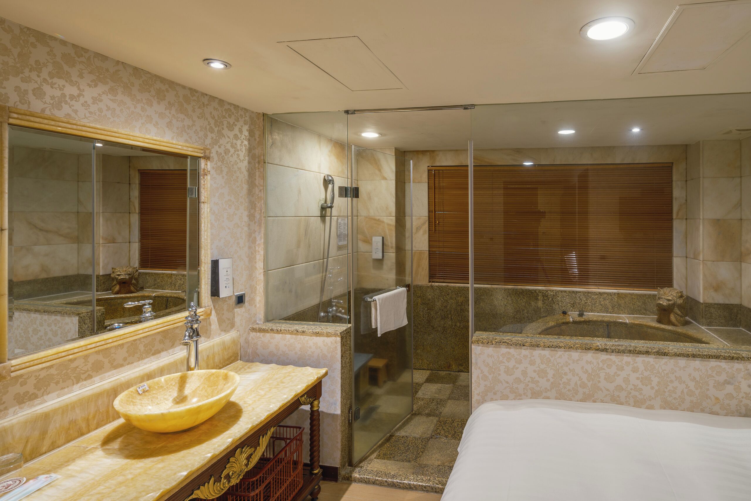 A modern bathroom with a large mirror, a bowl sink, a shower enclosure, and a separate bathtub.