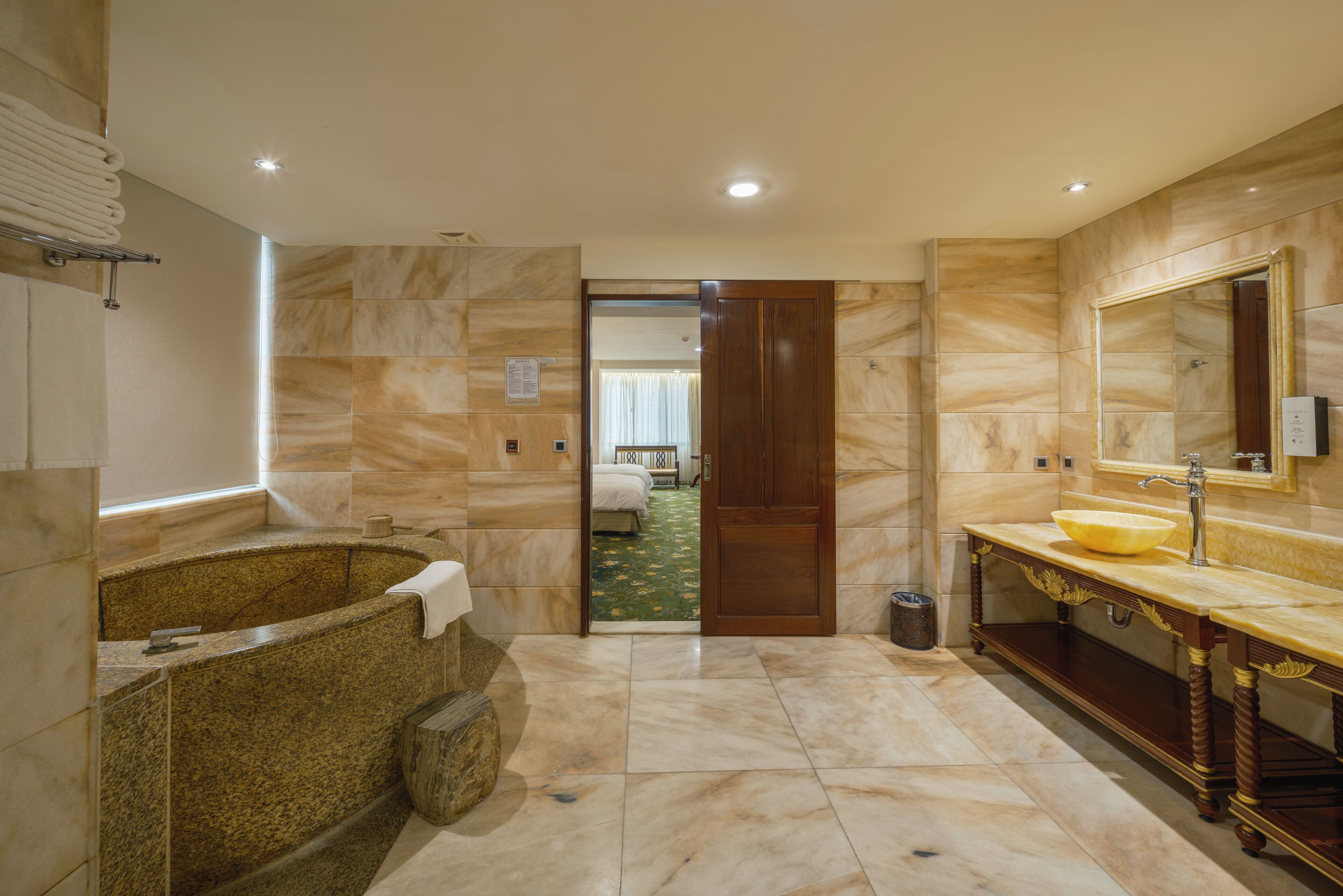 A modern bathroom with a freestanding bathtub, a vanity with a large mirror, and a shower area.