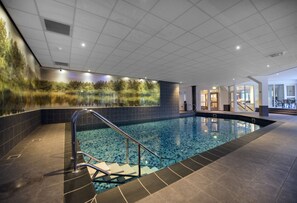 An indoor swimming pool with a glass wall, tiled flooring, and a staircase leading into the pool. - Boshotel Vlodrop (Vlodrop)