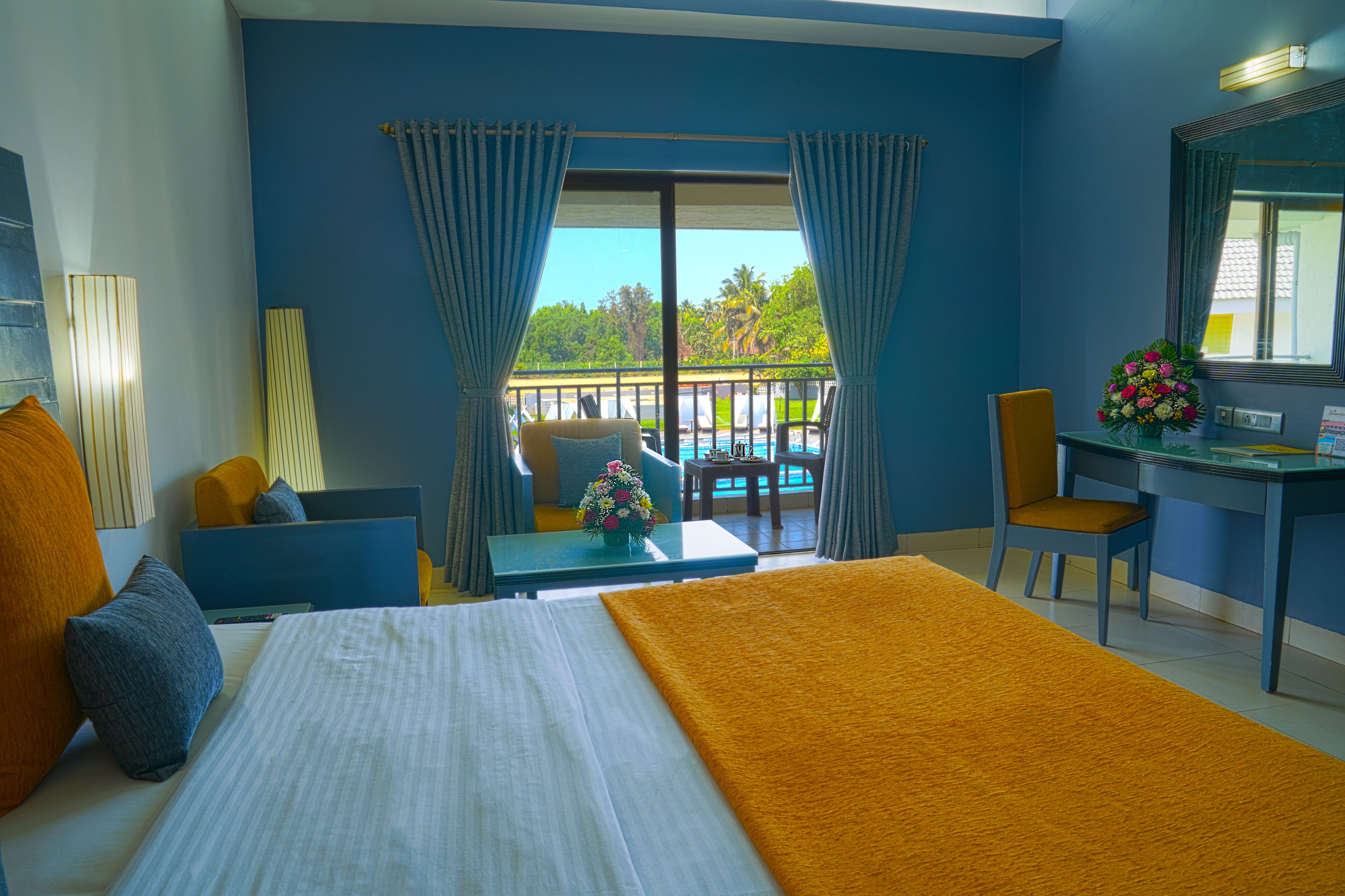 Deluxe Pool View Room | Minibar, in-room safe, desk, blackout drapes