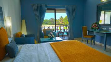 Deluxe Pool View Room | Minibar, in-room safe, desk, blackout drapes