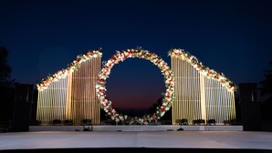 A stage with a floral arch and seating. - Regenta Baywatch Resort Goa (Colva)