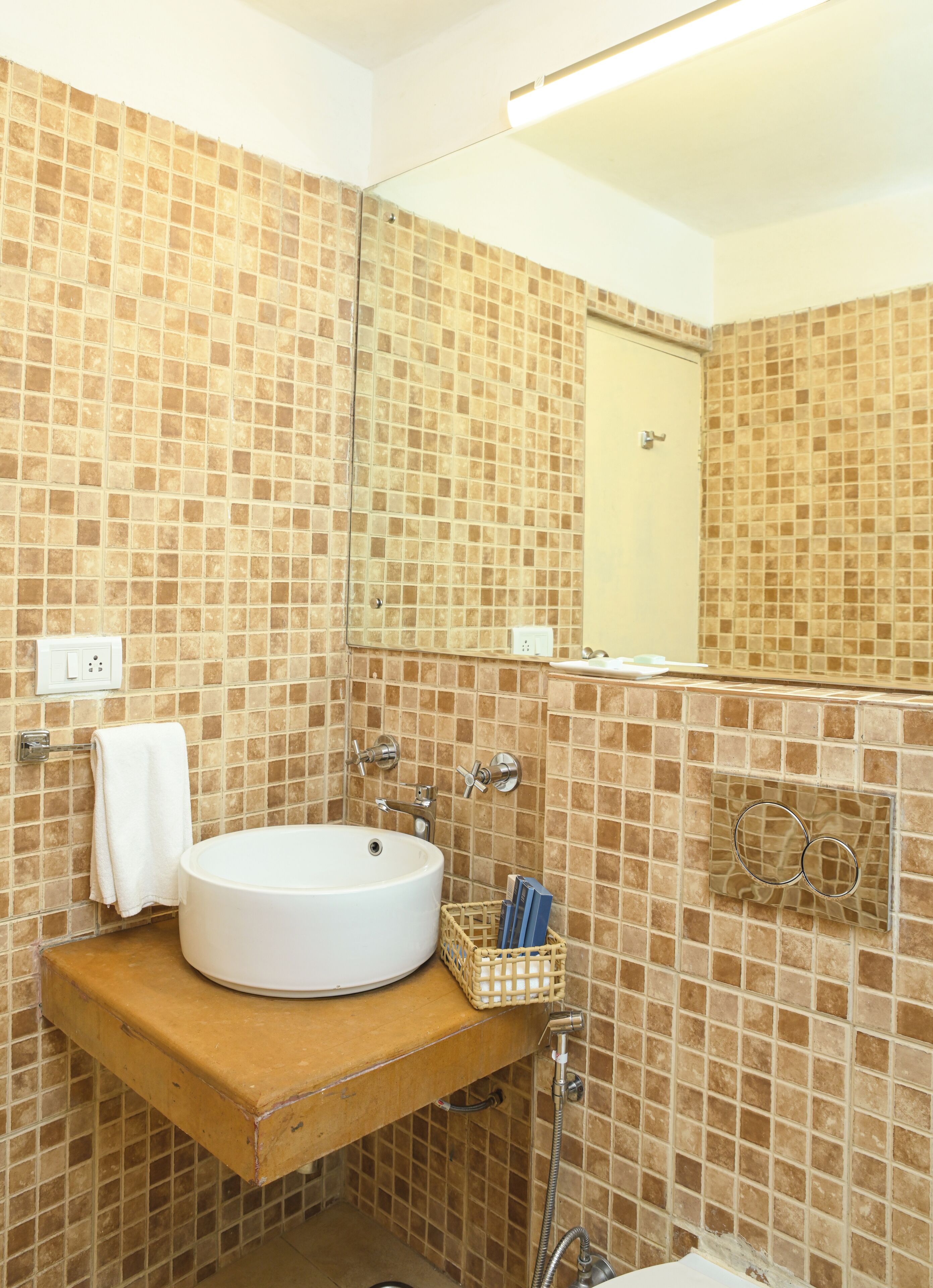A bathroom with a white sink, a mirror, and tiled walls.