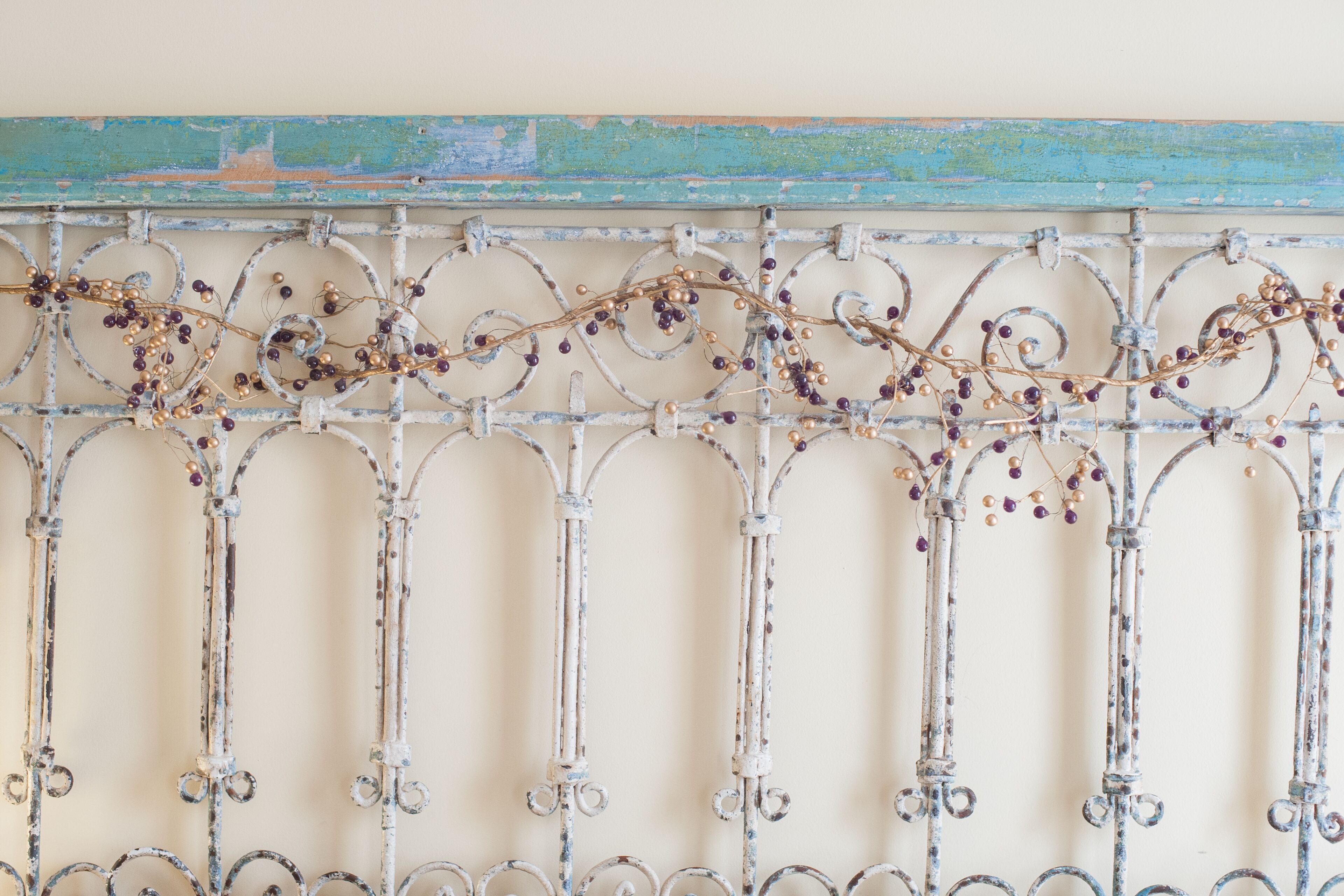 A metal gate with intricate scrollwork and decorative vines.