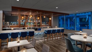 A modern bar area with seating and a bar counter. - La Quinta Inn & Suites by Wyndham Chicago Downtown (Chicago)