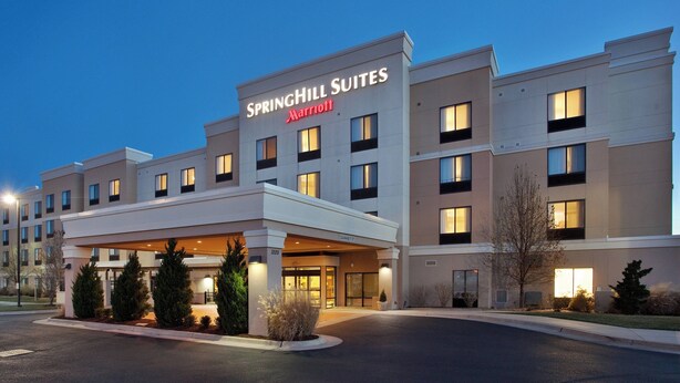 A Springhill Suites Marriott hotel with a modern facade, multiple windows, and a covered entrance area. - SpringHill Suites by Marriott Wichita East at Plazzio (Wichita)