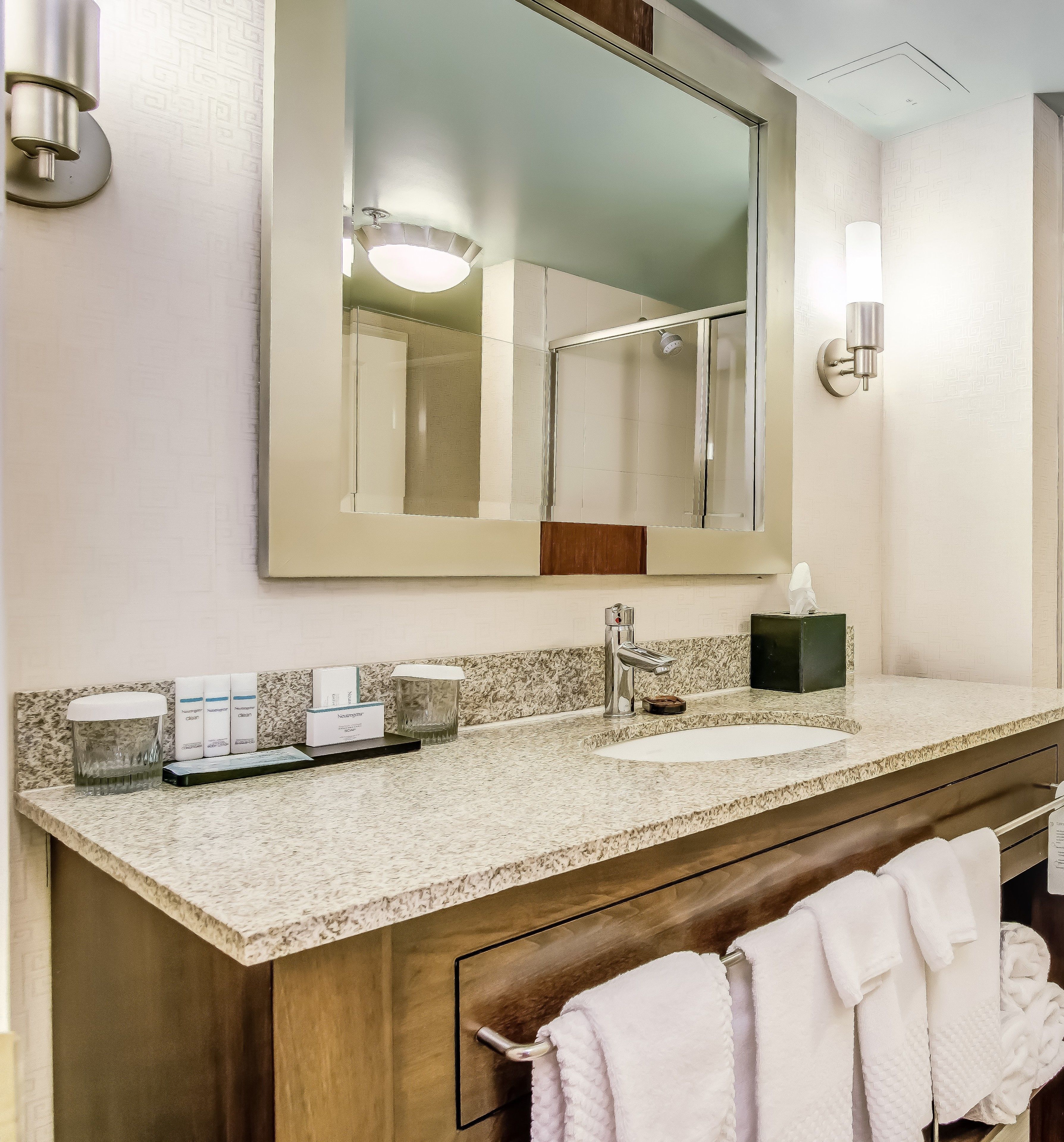 designer toiletries, hair dryer, towels