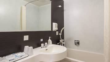 A bathroom with a white sink, dark brown wall, and a mirror.