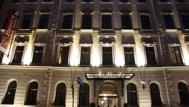 A historic building with a classic architectural style, featuring arched windows and a prominent entrance with a sign that reads "Hotel Bristol." - Hotel Bristol Budapest (Budapest)