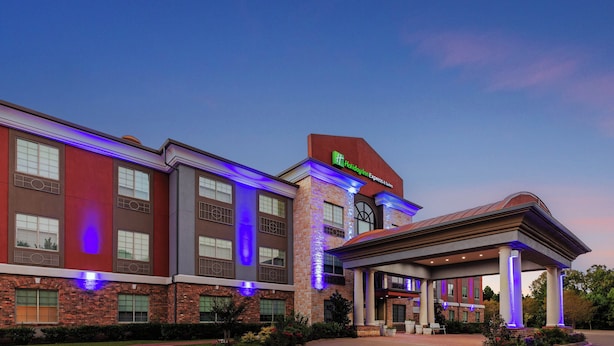 A Holiday Inn Express & Suites hotel with a brick facade, large windows, and a covered entrance area. - Holiday Inn Express and Suites Henderson by IHG (Henderson)