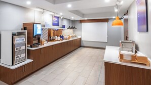 A modern kitchen with a yogurt dispenser, eggs, and milk station, wooden cabinets, and a white countertop.