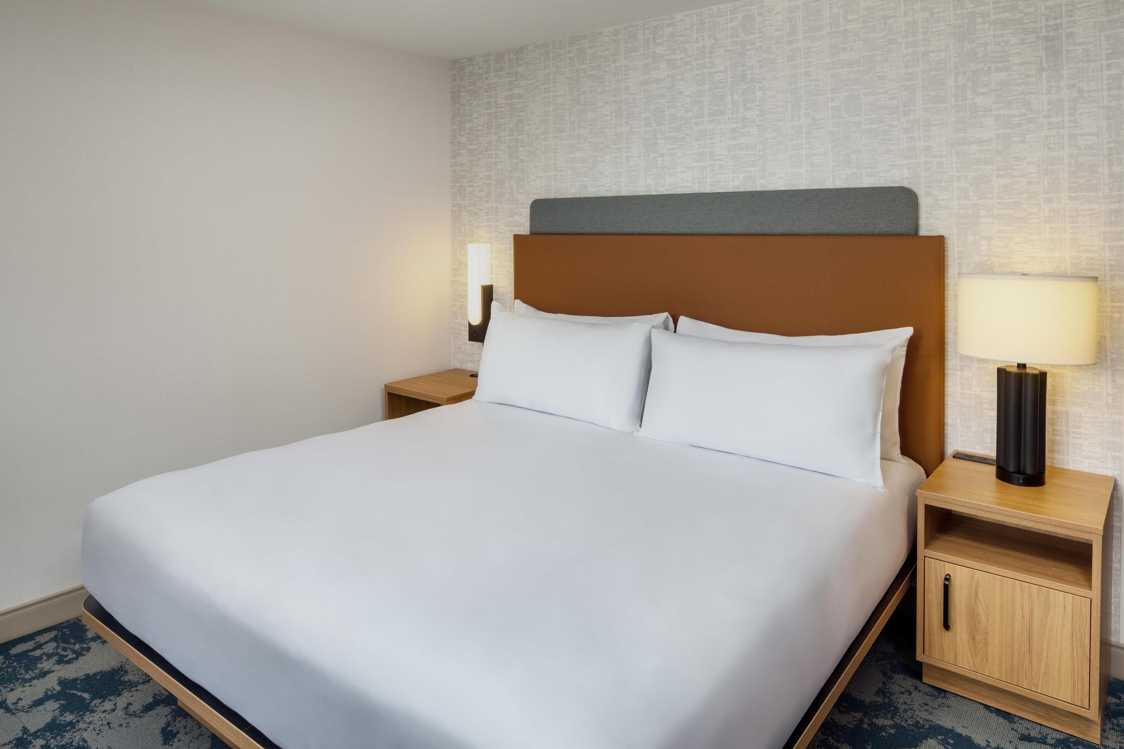 hypo-allergenic bedding, desk, laptop workspace, blackout curtains