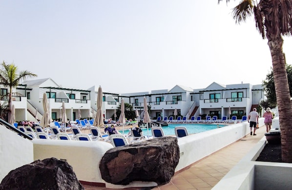 Outdoor pool, a rooftop pool, open 10:00 AM to 6:00 PM, pool umbrellas