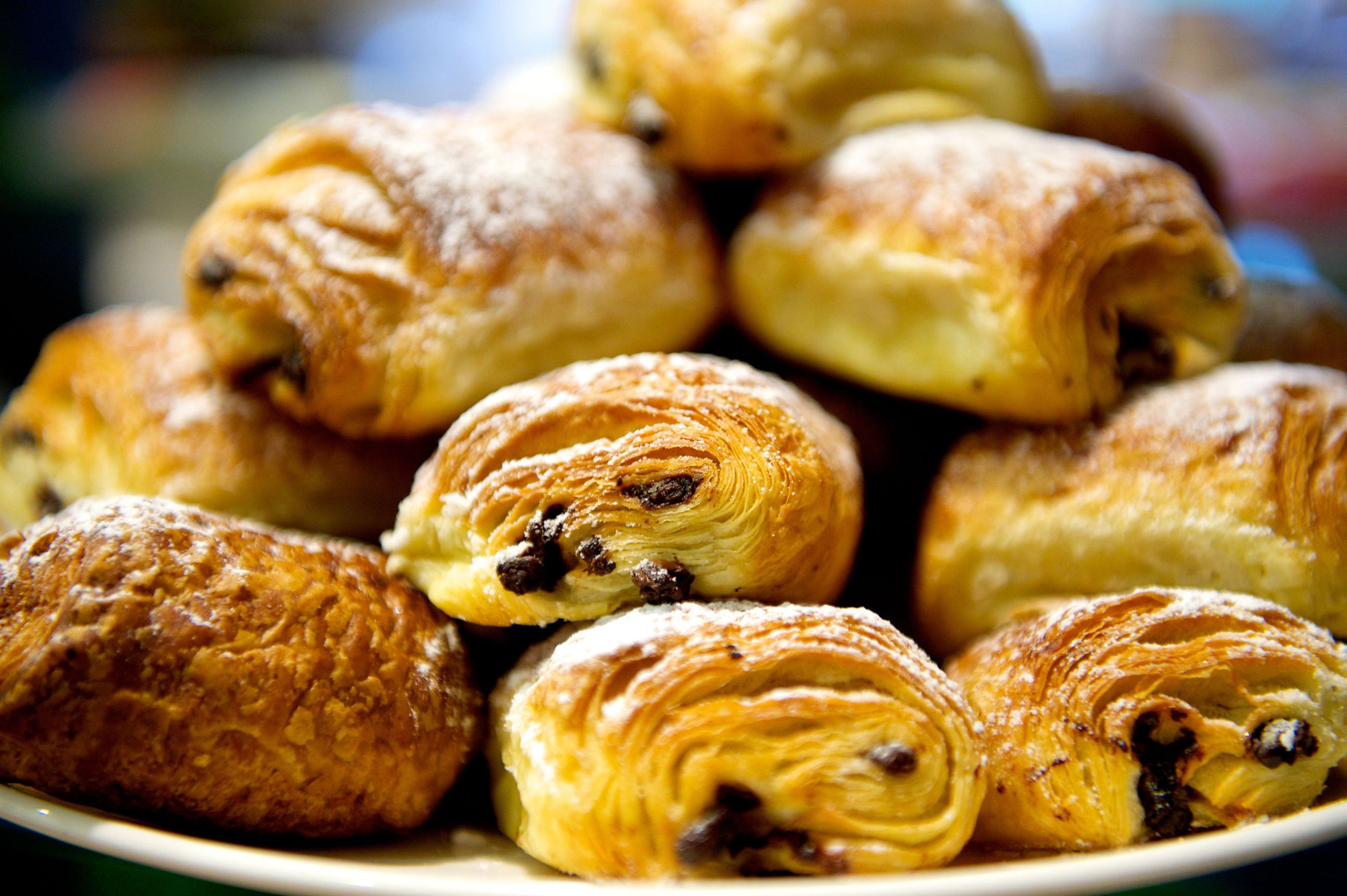 A plate of assorted pastries, including croissants and chocolate-filled rolls.