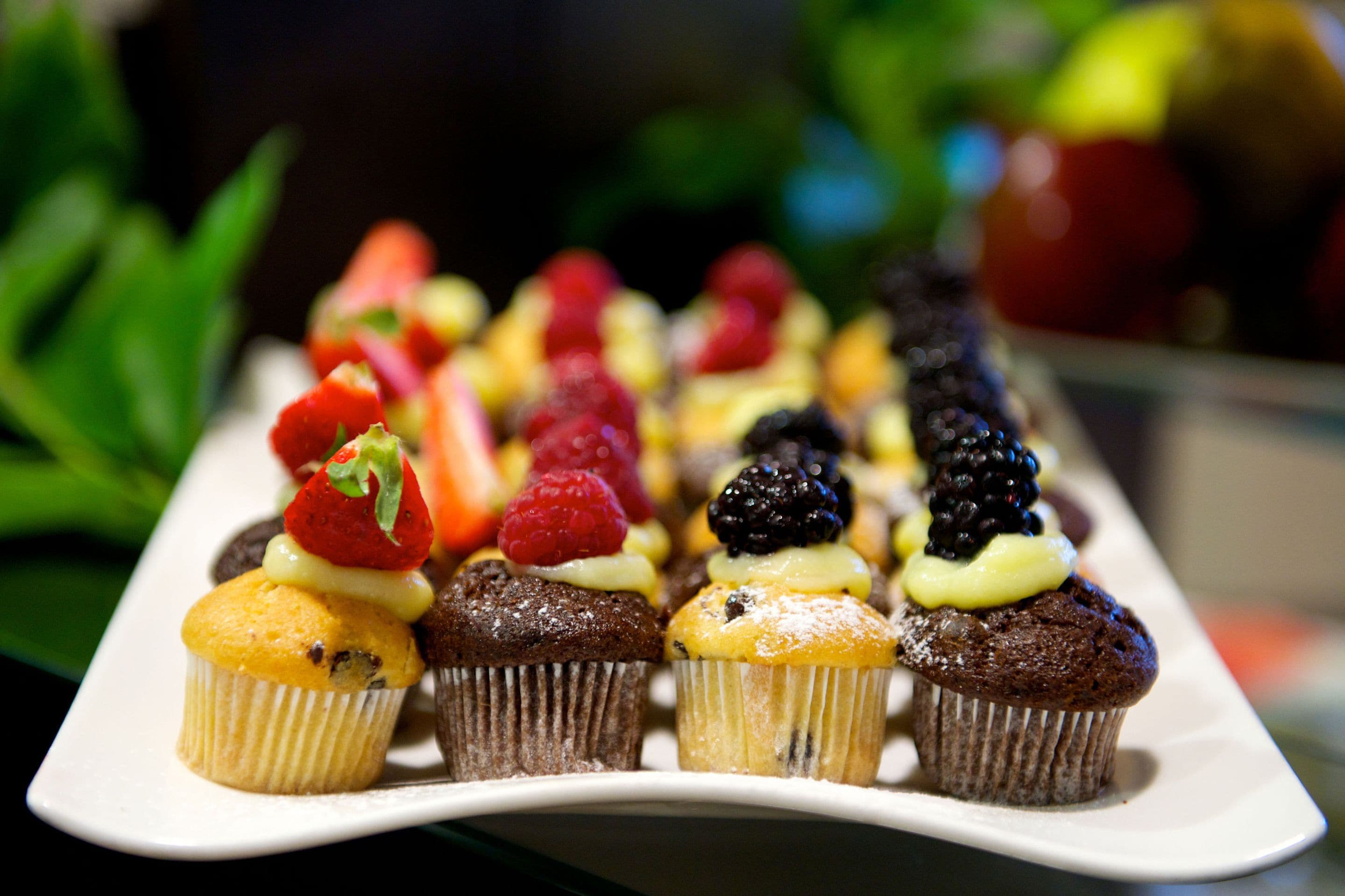 A tray of assorted cupcakes with various toppings.
