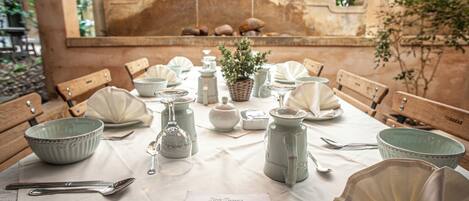 A table set for a meal with a menu, bowls, plates, and cutlery.