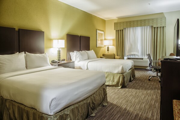 A hotel room with two beds, a desk, a chair, a lamp, and a large window with curtains. - Holiday Inn Express & Suites Waller - Prairie View by IHG (Waller)