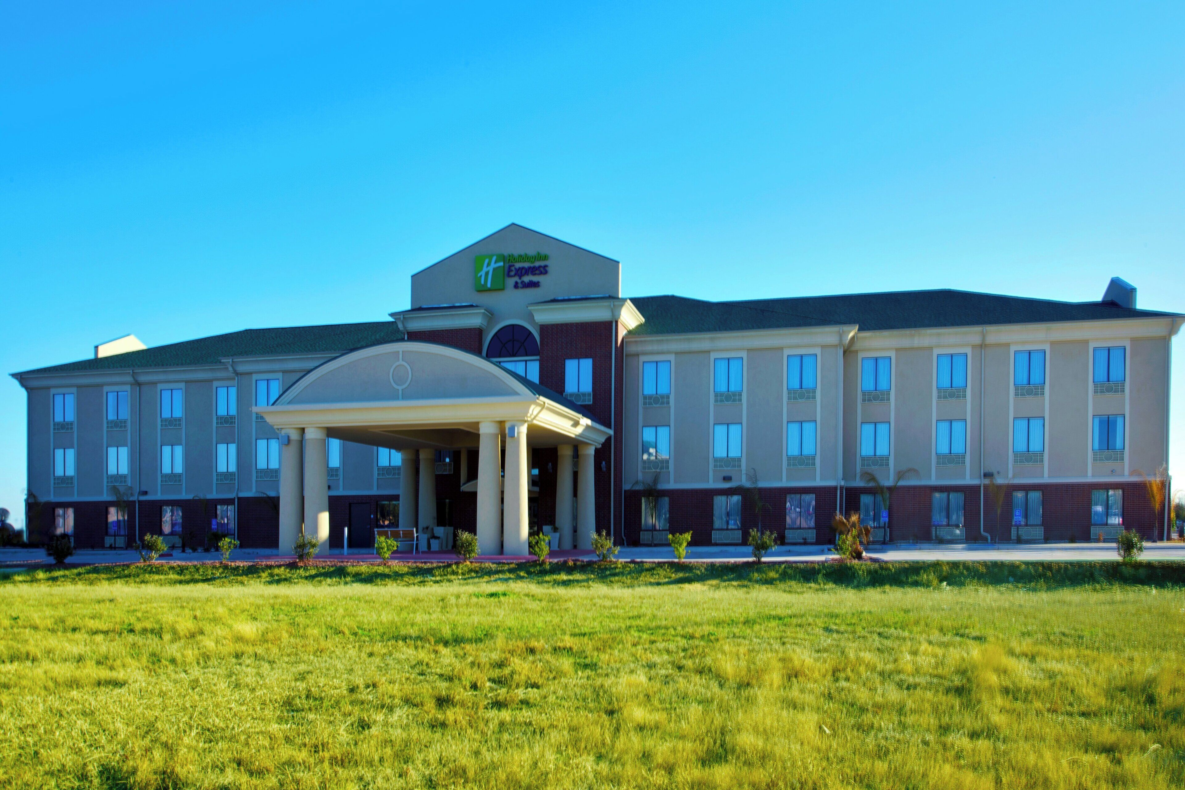 A large hotel with a central entrance pavilion, multiple windows, and a flat roof.