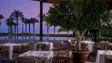 Enjoy al fresco dining amidst lush surroundings and a picturesque view.