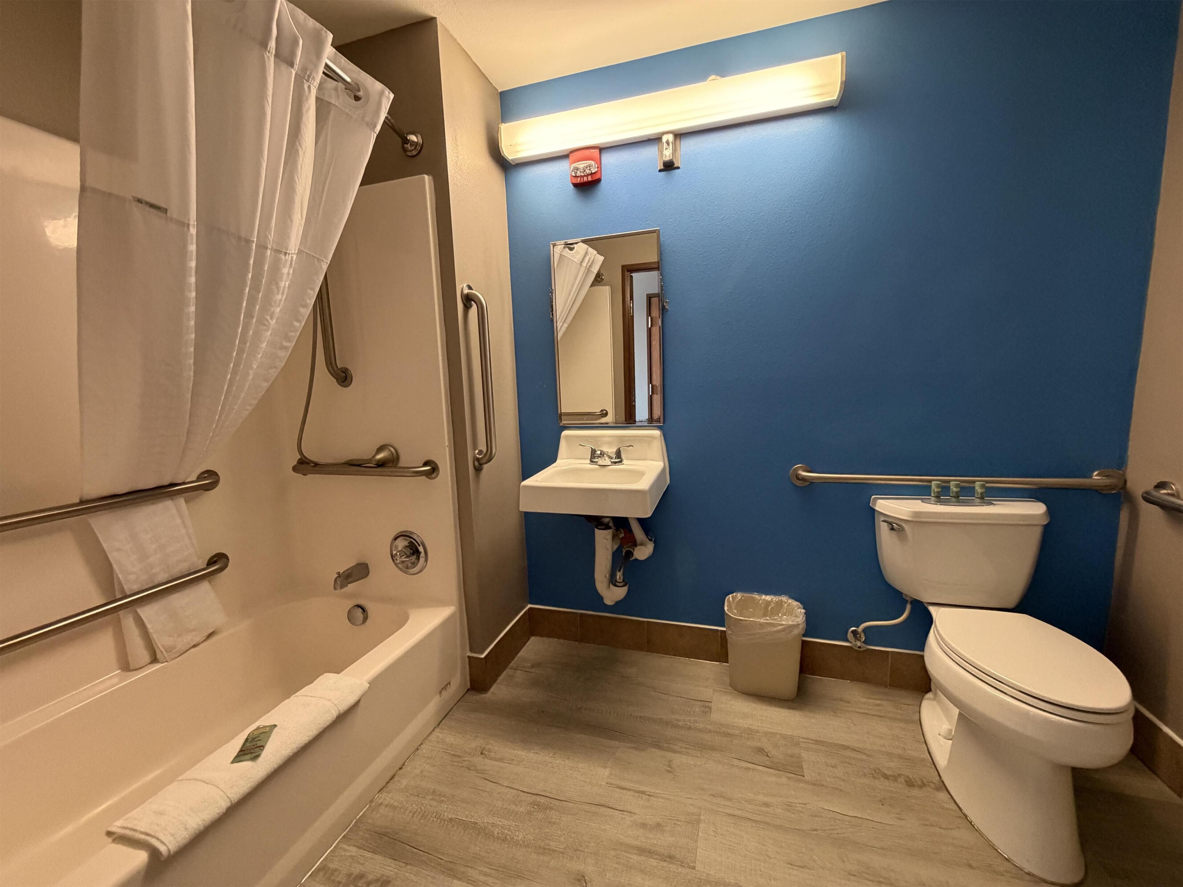 A bathroom with a bathtub, a sink, and a toilet.