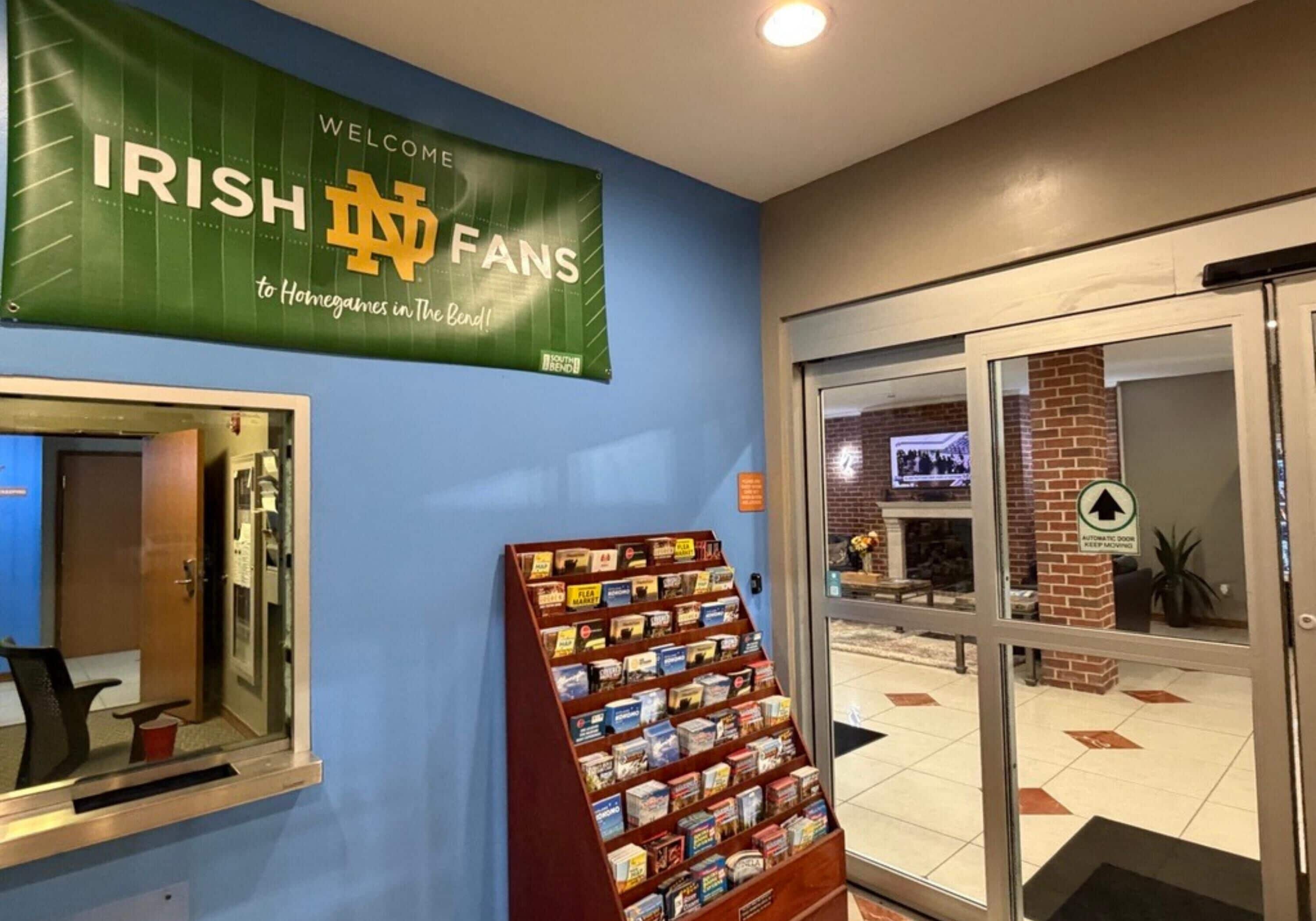 A reception area with a banner reading 'IRISH FANS welcome to Homegames in The Bend!' and a display of books or magazines.