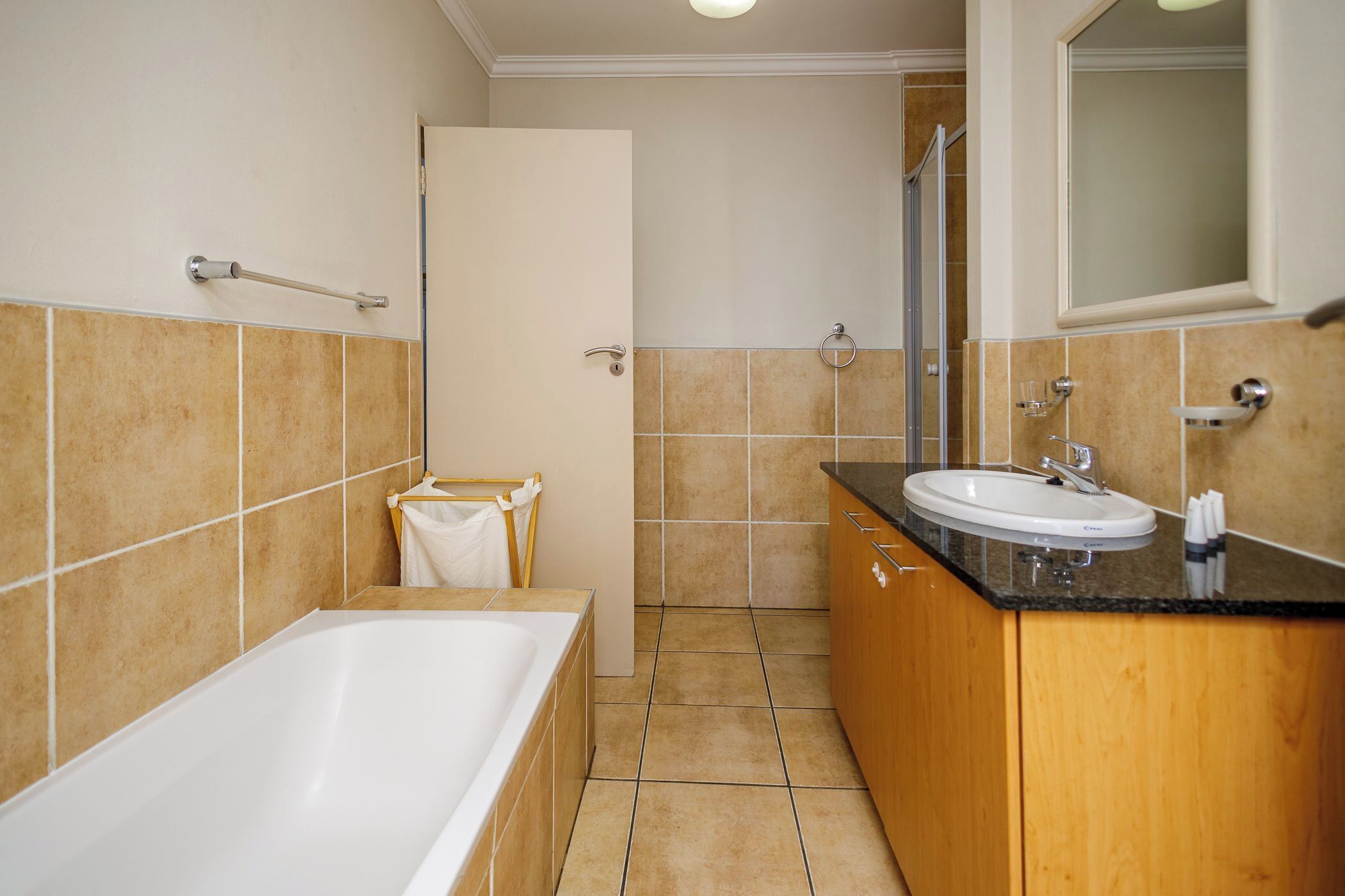 A bathroom with a bathtub, a sink, and a shower.