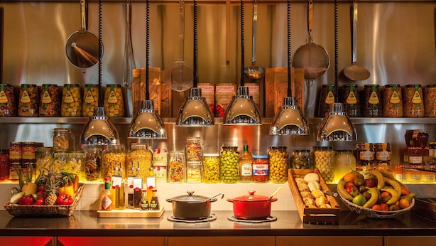 A kitchen counter with various food items and condiments.