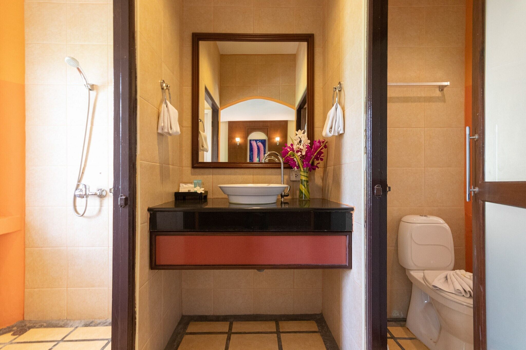 A bathroom with a sink, mirror, and toilet.