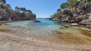 A clear coastal area with rocky terrain and calm waters. - Hotel Petit Cala Fornells (Calvia)