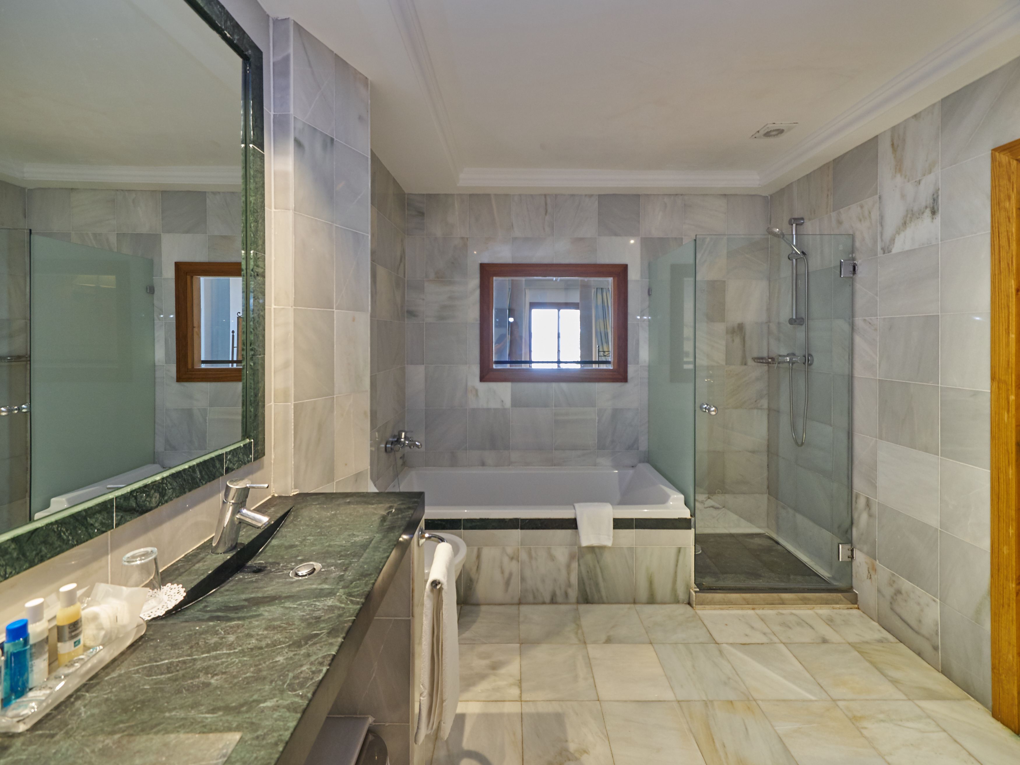 junior suite, sea view | bathroom | hydromassage showerhead, designer toiletries, hair dryer, bathrobes