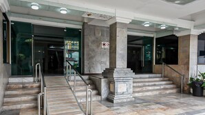 A marble-floored entrance with a staircase, metal handrails, and a no-smoking sign. - Pattaya Hiso Hotel (Pattaya)