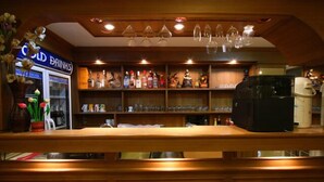 A bar area with shelves of liquor bottles, a coffee machine, and a sign for 'Cold Drinks'. - Honey House 2 (Bangkok)