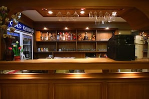 A bar area with shelves of liquor bottles, a coffee machine, and a sign for 'Cold Drinks'. - Honey House 2 (Bangkok)