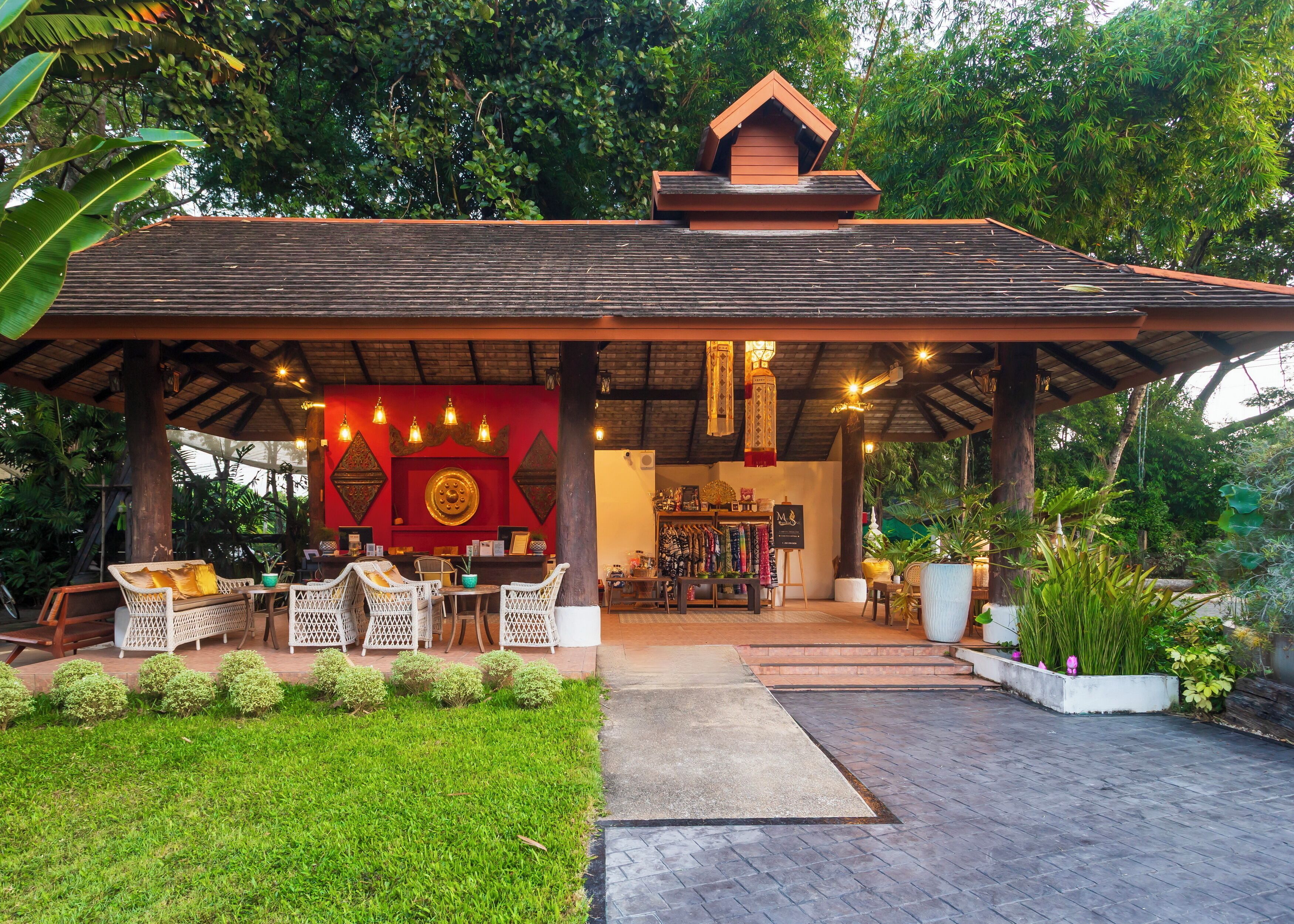 A covered outdoor area with seating and a reception desk.