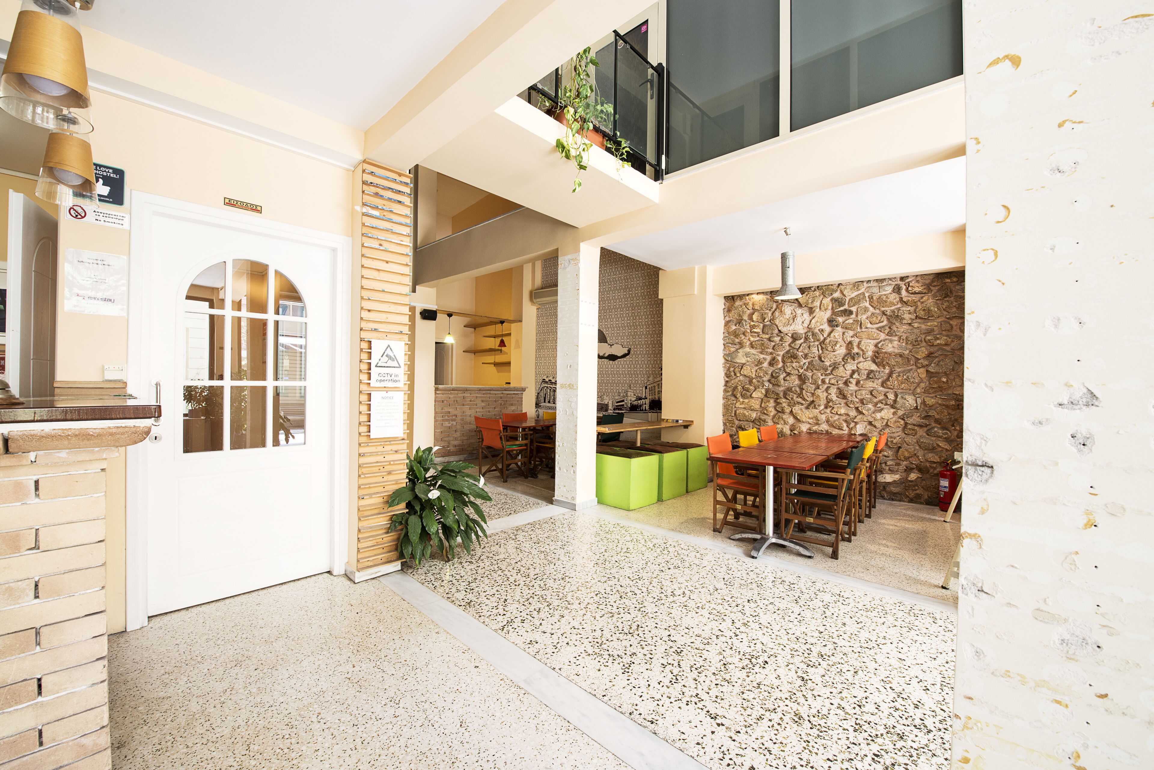 A spacious interior with a kitchen area, dining table, and seating.