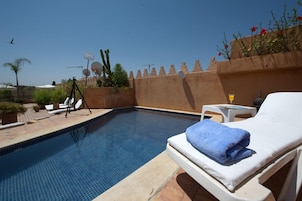 Seasonal outdoor pool, open 9:00 AM to 9:00 PM, sun loungers