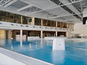 A large indoor swimming pool with a high ceiling and modern architecture. - Park Inn by Radisson Meriton Conference & Spa Hotel Tallinn (Tallinn)