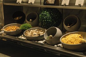 A buffet with various food items in bowls, including nuts, dried fruit, and seeds. - Park Inn by Radisson Meriton Conference & Spa Hotel Tallinn (Tallinn)