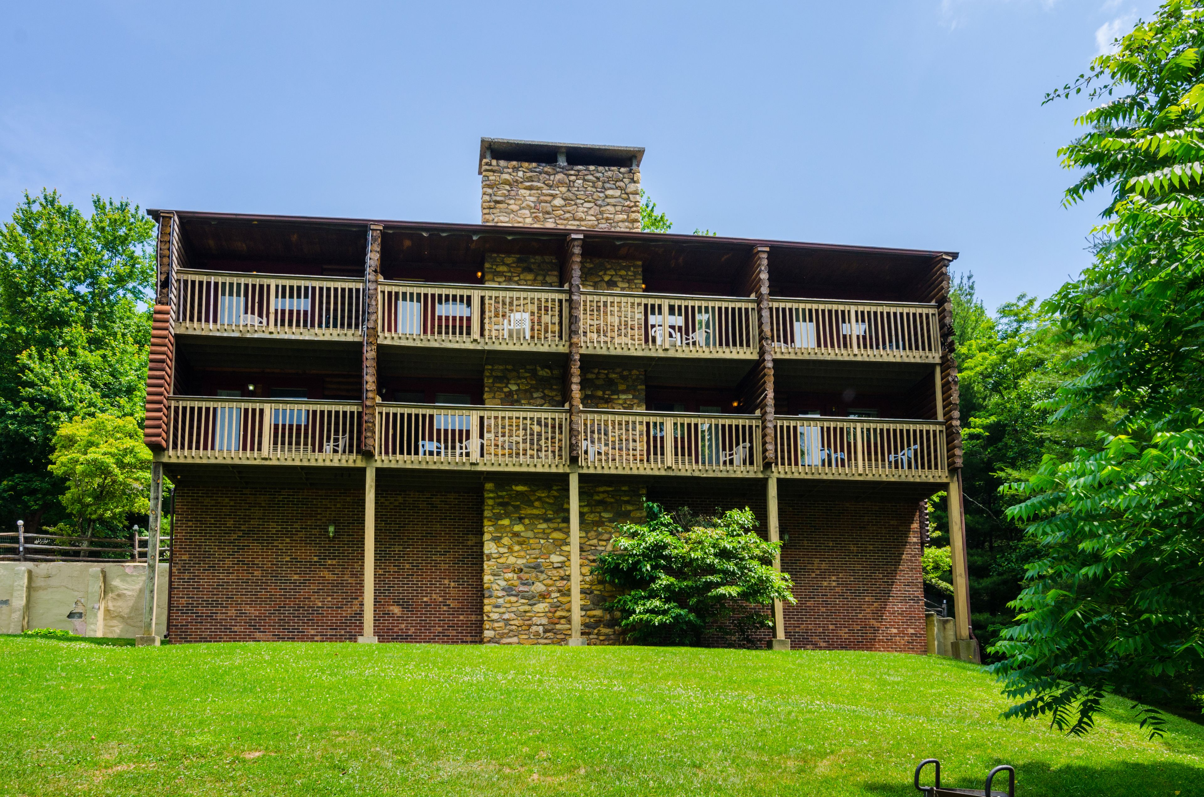 A two-story building with a stone facade and multiple balconies.