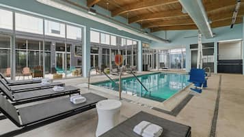 A pool area with lounge chairs and a diving board.