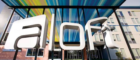 Entrada de hotel con letras blancas grandes que dicen "flore" y "hotels".