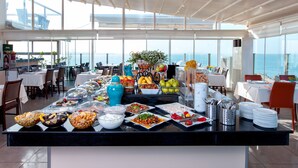 A buffet setup with various food items and a view of the sea. - Ferman Hotel Old City - Special Class (Istanbul)