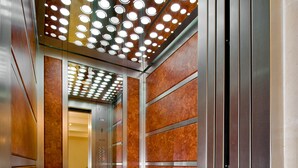 An elevator with a mirrored wall, a glass floor, and a ceiling with circular lights. - Ferman Hotel Old City - Special Class (Istanbul)