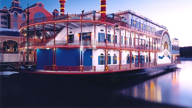 A large paddle steamer with multiple decks and a prominent chimney.
