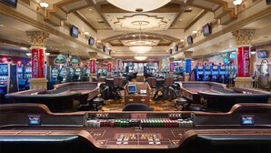 A casino with multiple gaming tables and slot machines.
