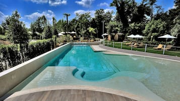 Seasonal outdoor pool, open 9:30 AM to 7:30 PM, pool umbrellas