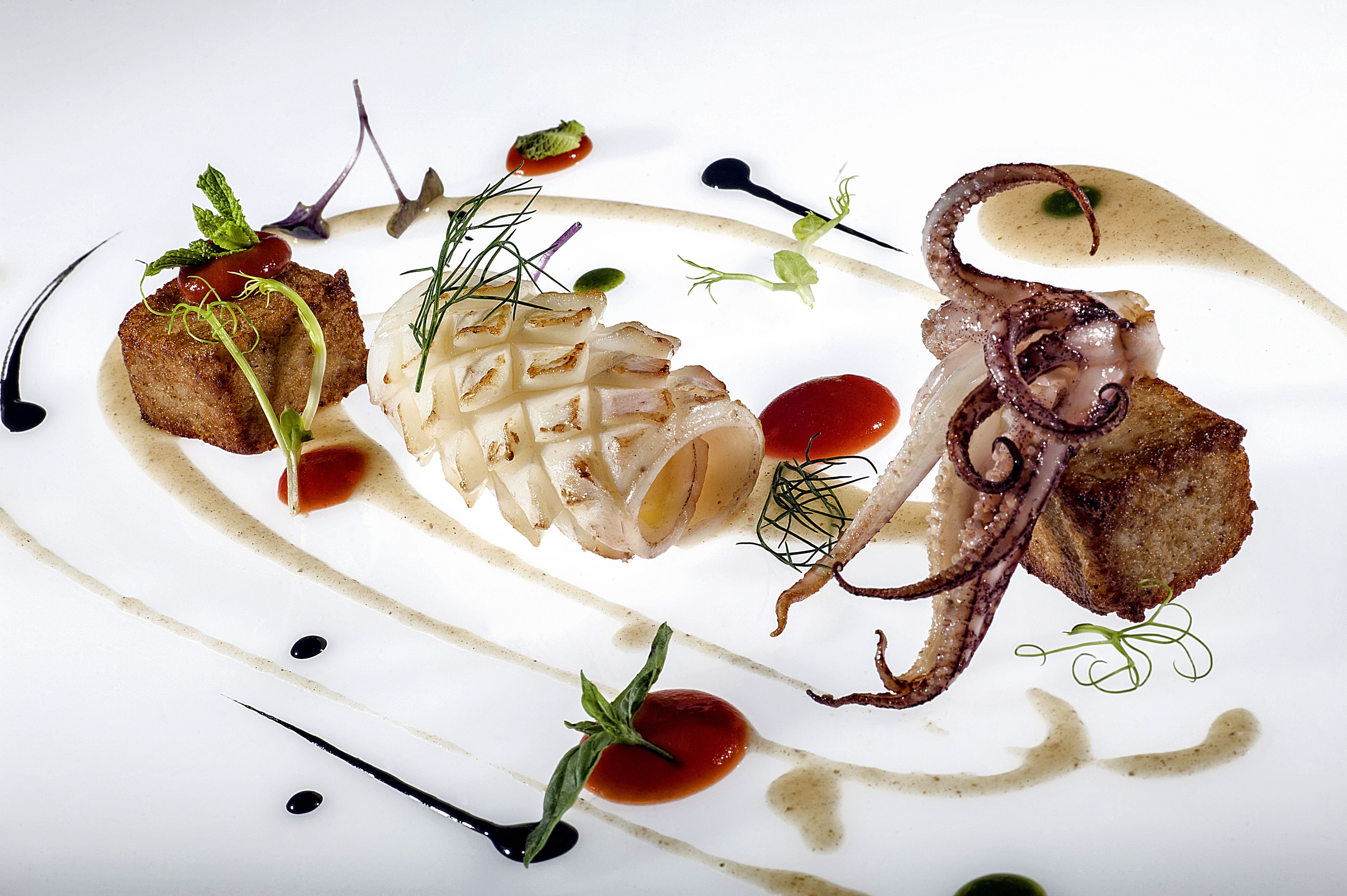 A white plate with various food items and sauces.