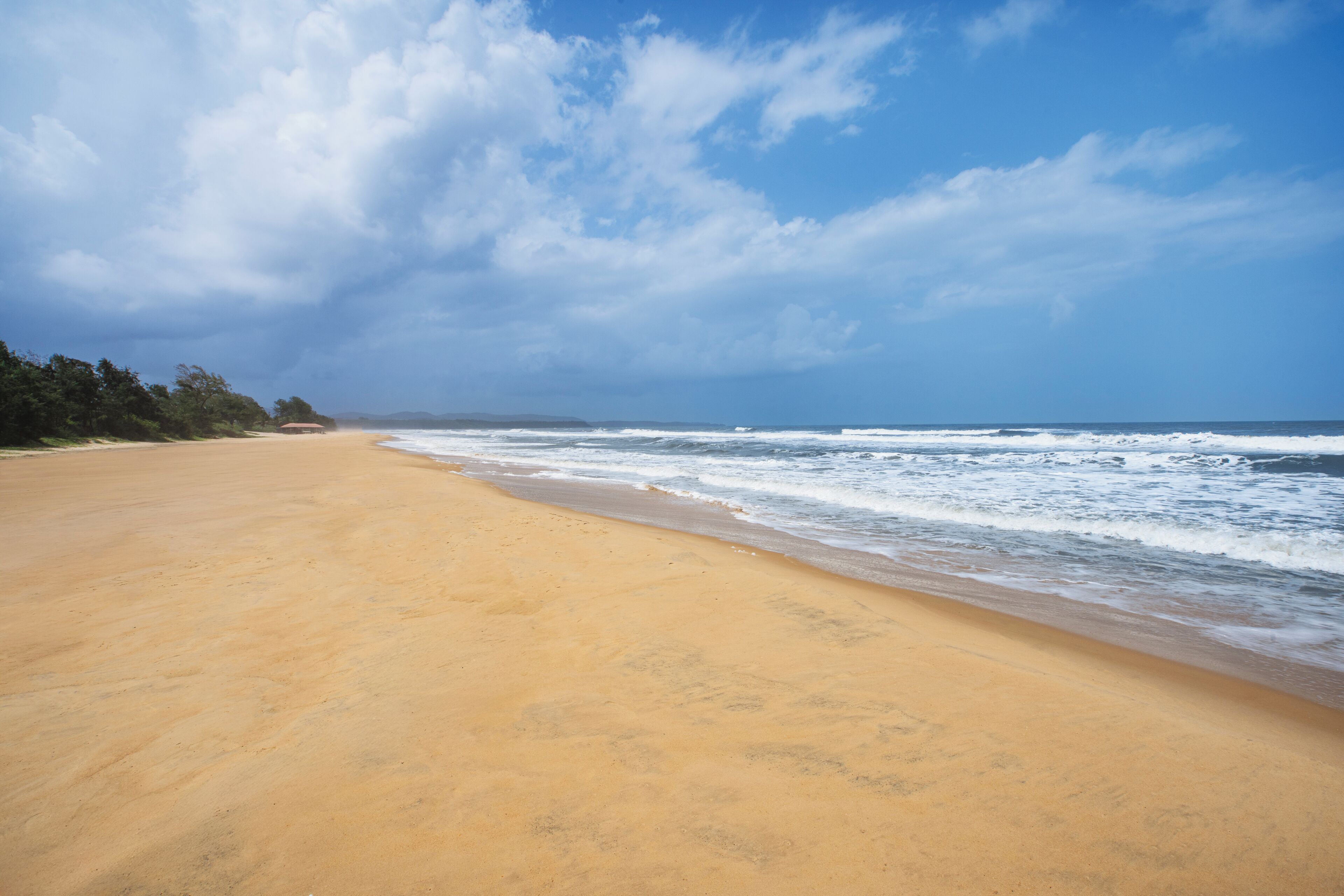 A beach with a clear sky and ocean waves.