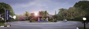 A hotel entrance with a curved driveway, a sign reading "NOVOTEL", and a golf cart in the background. - Novotel Goa Dona Sylvia Resort (Cavelossim)